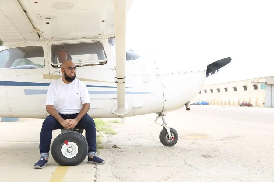 Muhammad Ahsan beside a light aircraft
